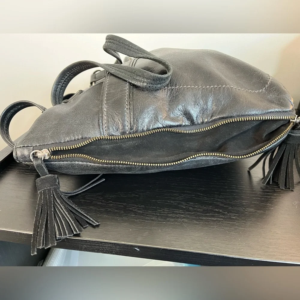 The Sak Expandable Black Leather Suede Shoulder Tote Bag with Suede Tassels